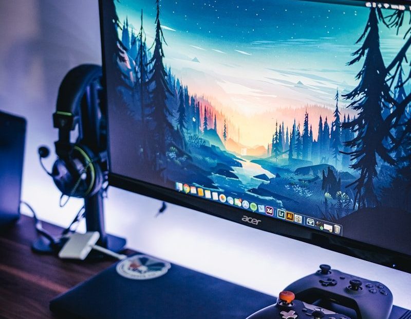 black Acer flat screen computer monitor mounted on white wall