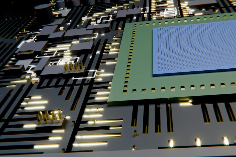 A circuit board with a central microchip and golden contacts.